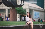 Woman breastfeeds baby at Raffles Place - 1