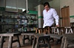 Village doctor without legs makes house calls on wooden benches - 6