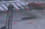 Video captures sinkhole collapsing in middle of busy road - 9