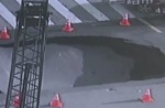 Video captures sinkhole collapsing in middle of busy road - 13