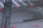 Video captures sinkhole collapsing in middle of busy road - 11