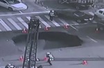 Video captures sinkhole collapsing in middle of busy road - 14