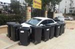 Trash cans barricade badly parked car in China - 2