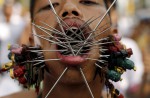Gruesome piercing at bizarre Thai vegetarian festival - 1