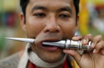 Gruesome piercing at bizarre Thai vegetarian festival - 4