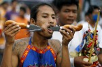Gruesome piercing at bizarre Thai vegetarian festival - 7