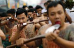 Gruesome piercing at bizarre Thai vegetarian festival - 11