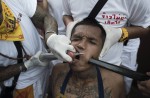 Gruesome piercing at bizarre Thai vegetarian festival - 27