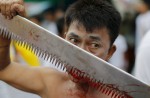 Gruesome piercing at bizarre Thai vegetarian festival - 35