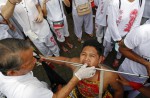 Extreme piercing for purity in Thai vegetarian festival - 11