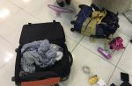 One budget airline passenger's badly damaged luggage and its contents - 13