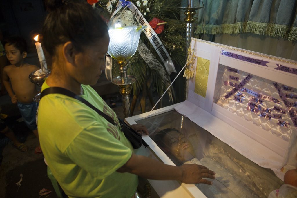 A mother mourns over the casket of her second son to be murdered by vigilantes near Road 10 Navotas, Manila. The drug war in the Philippines has led to the deaths of more than 3,000 suspects so far. Pic: Darius Askaripour.