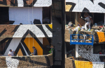 Graffiti artist creates mural spanning 50 buildings in Garbage City - 5