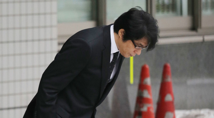 Japan singer calls police to report spying, is arrested