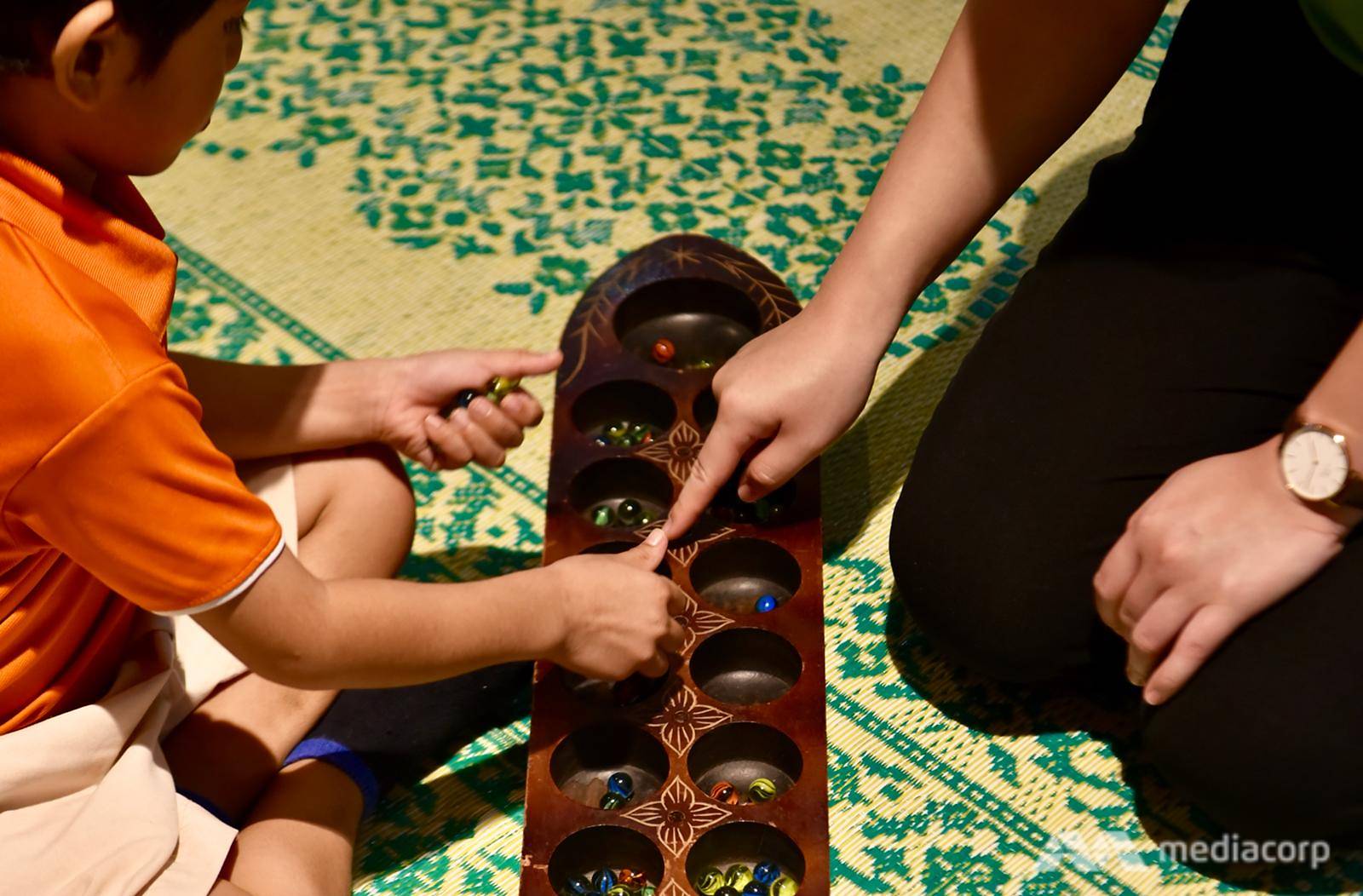 playing congkak at wisma geylang serai