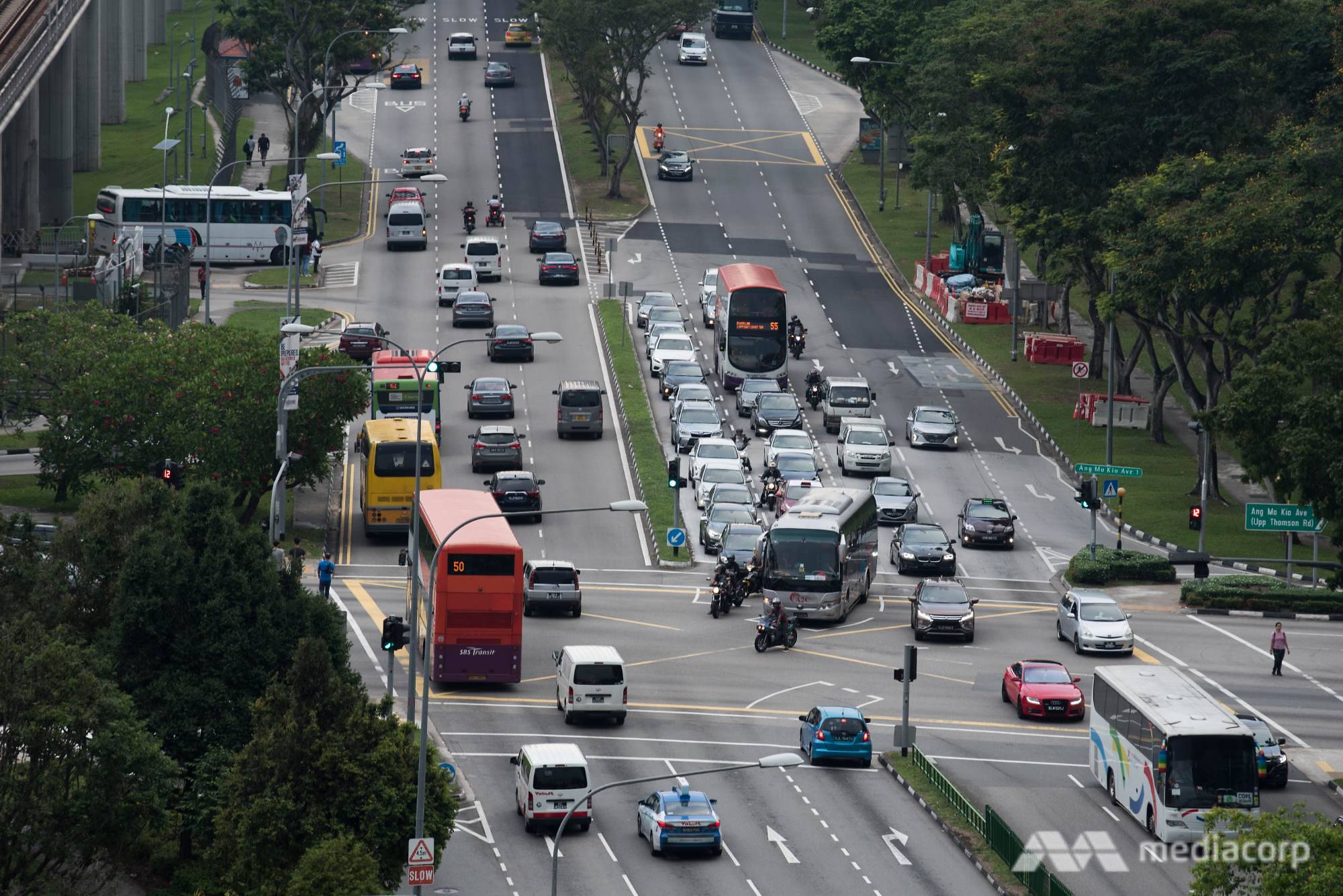 Traffic cars buses motorcycles on road in Singapore COE - file photo