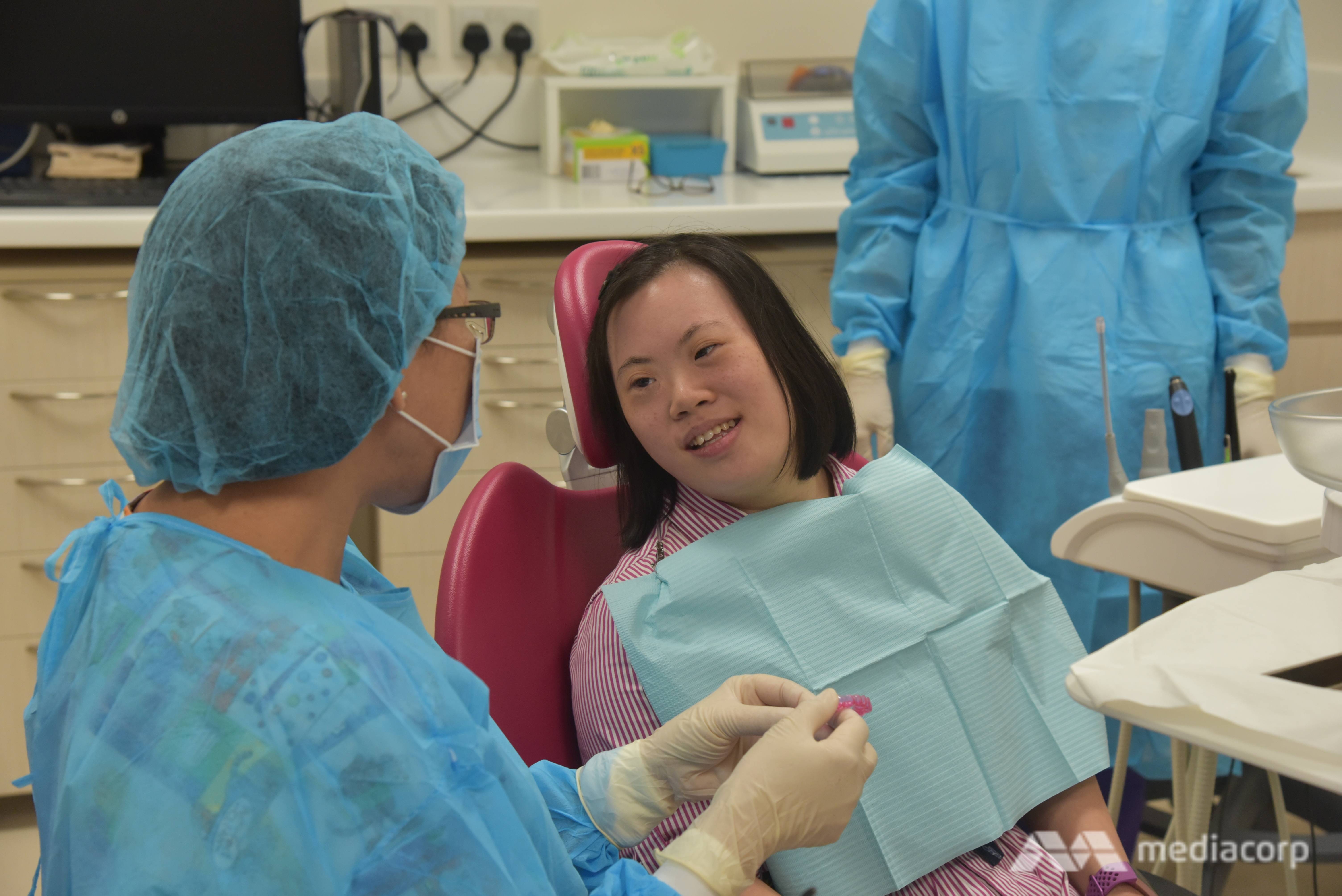 Ms Marianne Lim talks to her dentist at a consultation session