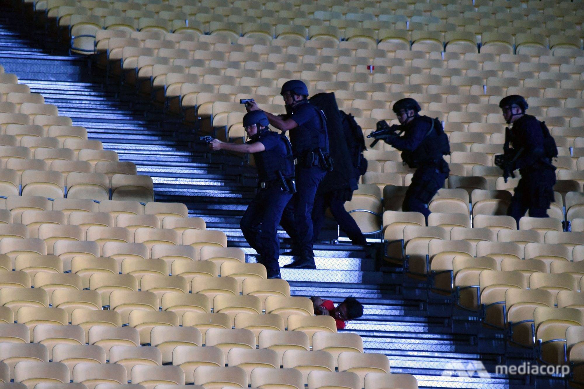 Ground Response Force police officers moving towards a "gunman" at an NDP counter-terrorism exercise