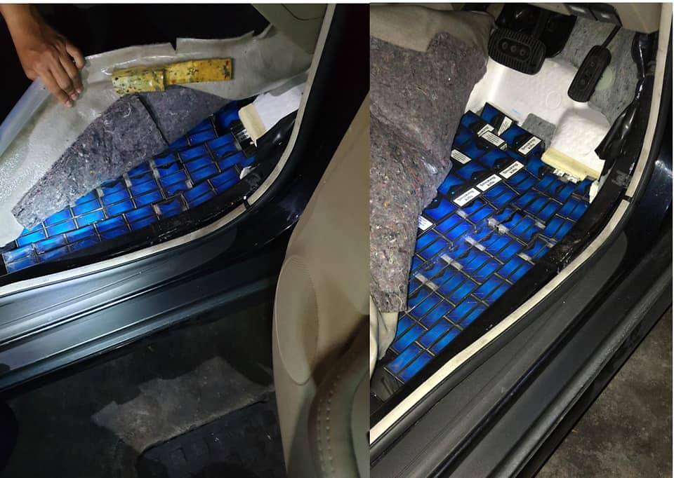 cigarettes underneath the floorboard of a Malaysia-registered car