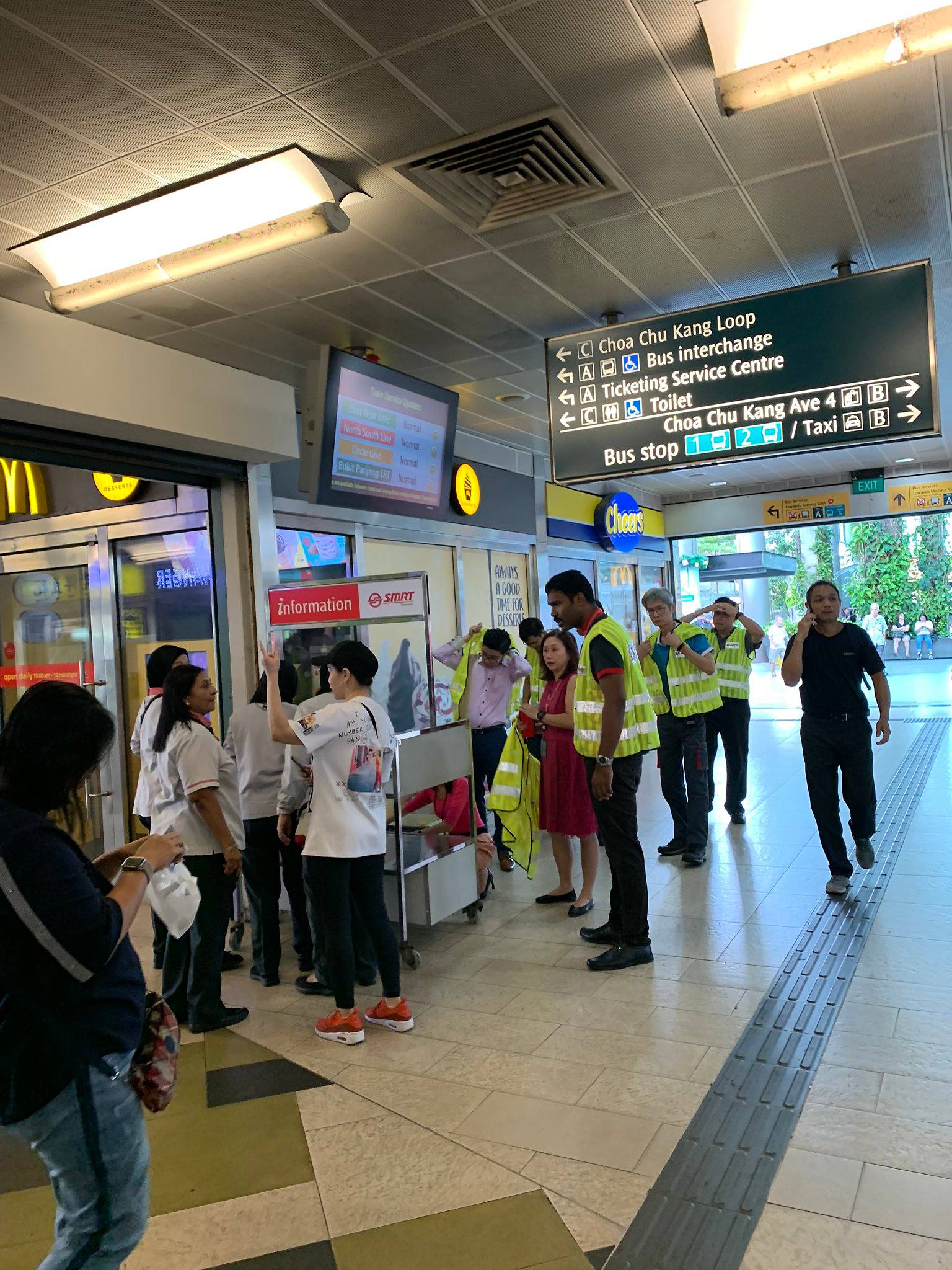 SMRT staff at Choa Chu Kang MRT station assisting commuters affected by the disruption