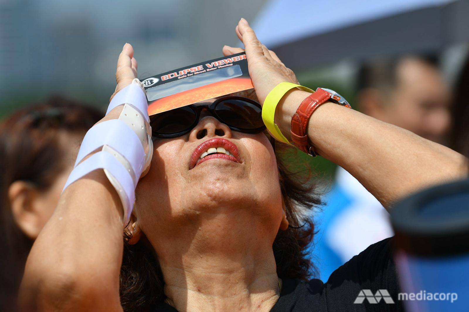 Woman using eclipse glasses