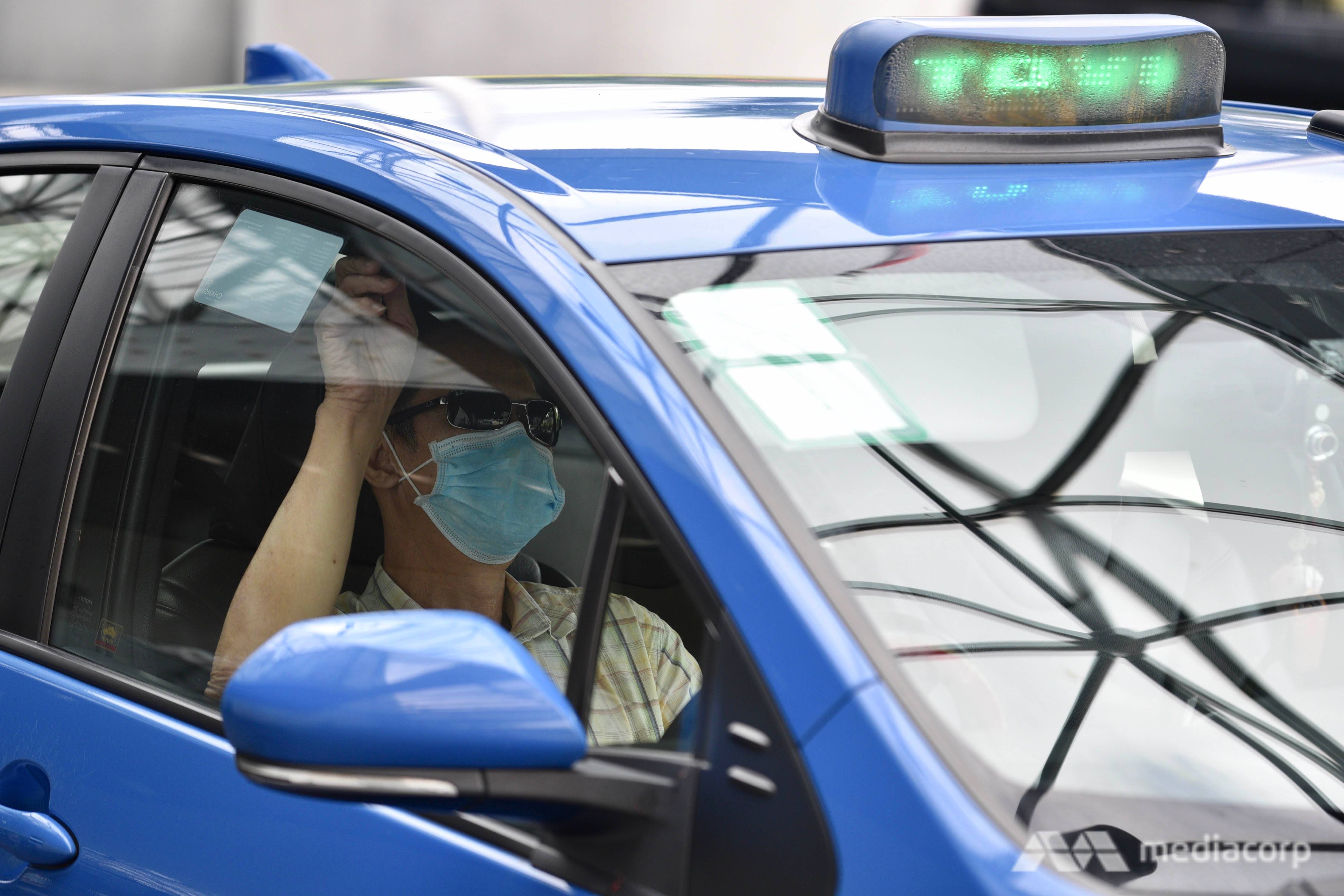 A taxi driver is seen waiting for passengers outside Swissotel The Stamford