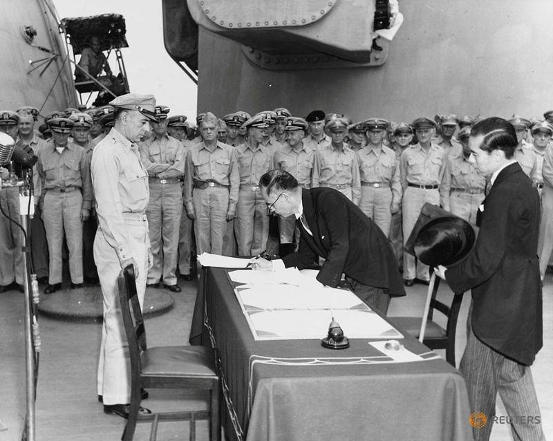FILE PHOTO: Japan's Foreign Minister Mamoru Shigemitsu signs the Instrument of Surrender onboa
